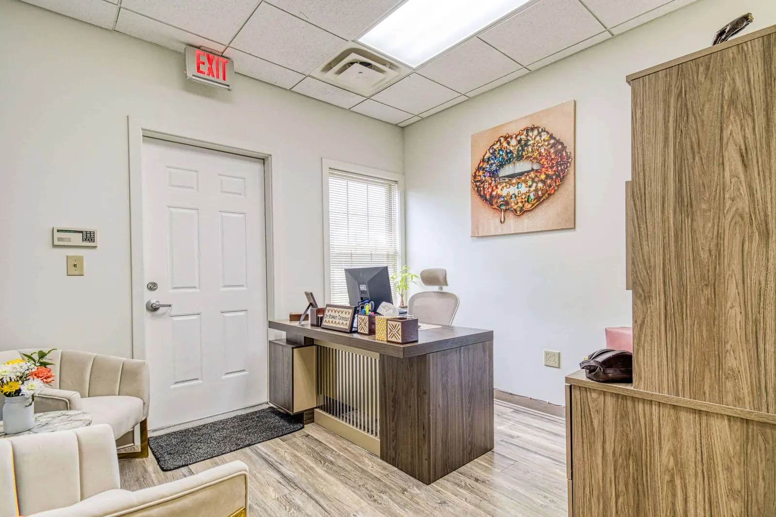 A quiet consultation room with a desk and seating
