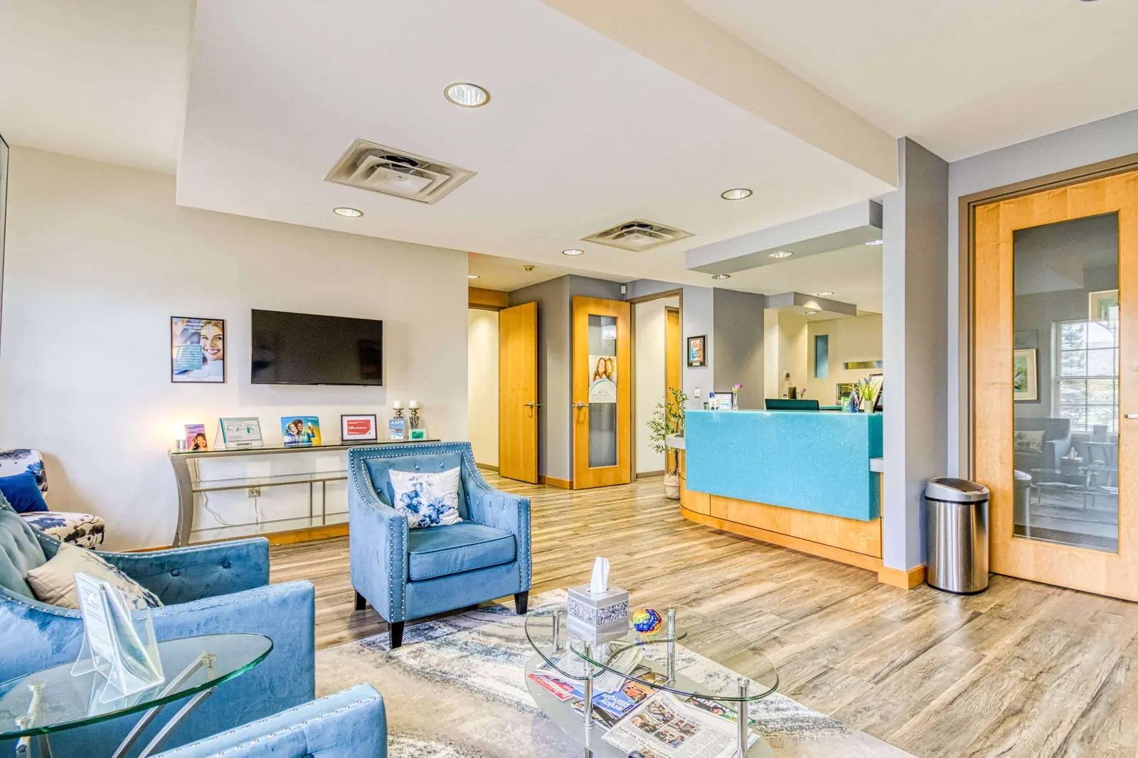 A lounge area with teal seating and a bright window
