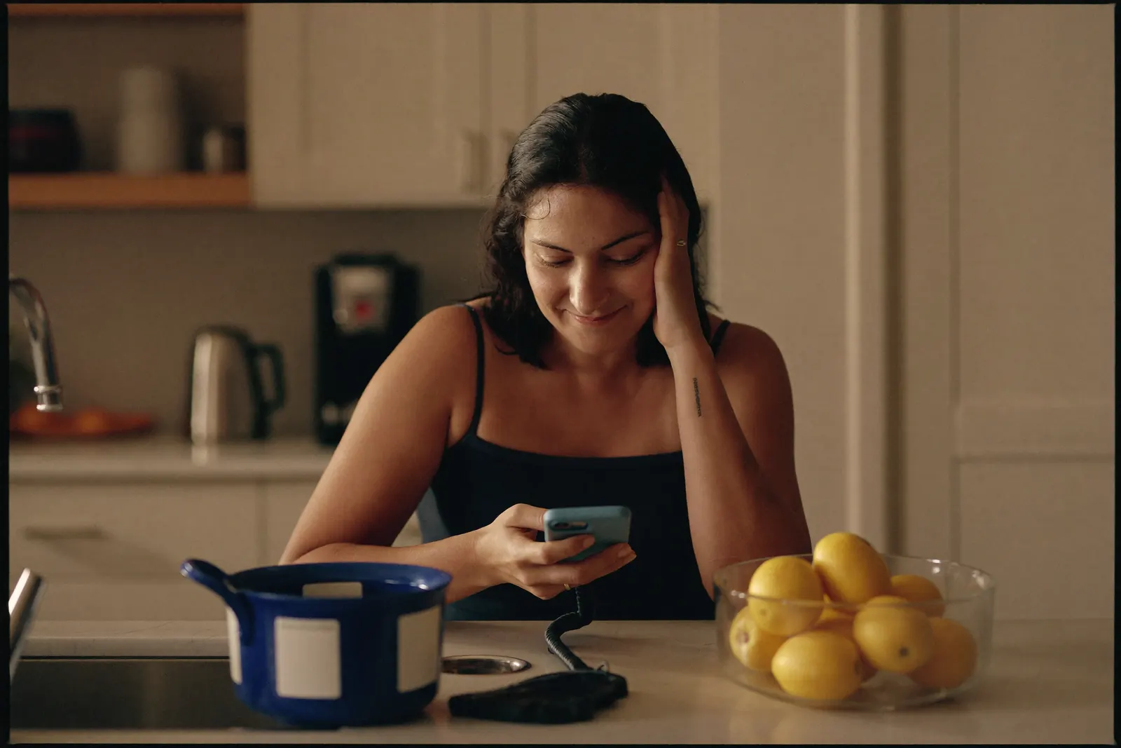 A woman looking at her phone with relief after booking an appointment